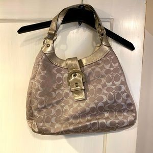 Coach silver monogrammed hobo bag.